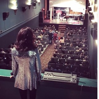 Picture of Lori Line on the Roxy Theater balcony overlooking the audience